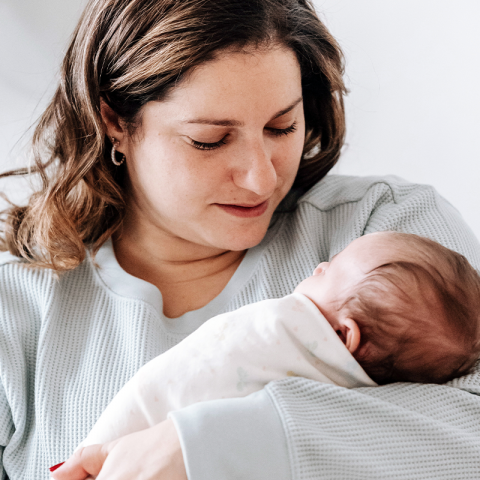 woman holding a newborn baby