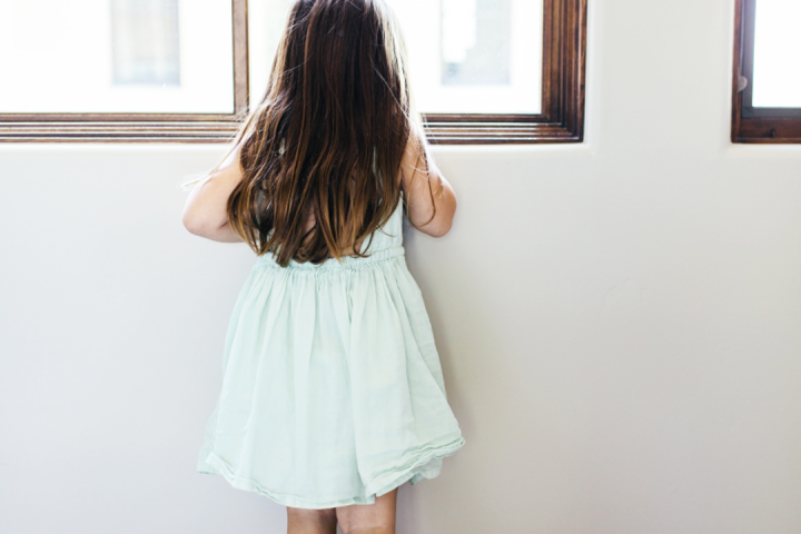 little girl looking out window