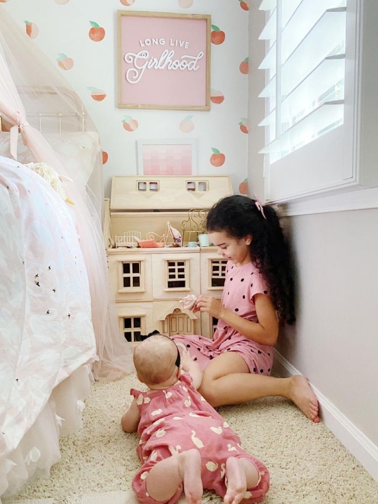 girls playing with dollhouse