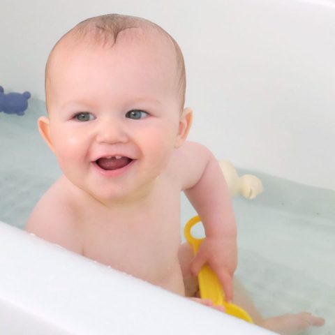 toddler standing up in the bathtub