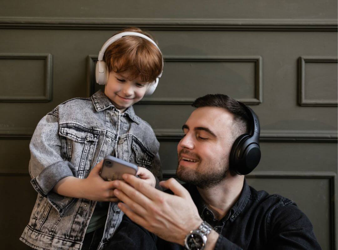 father and son listening to podcast best podcasts for kids