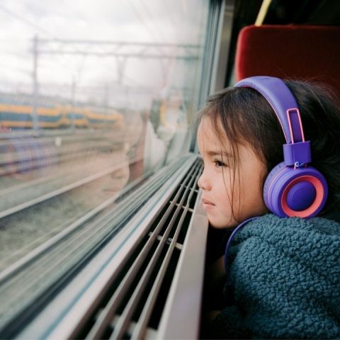 girl on train with headphones