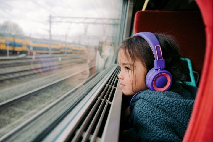 girl on train with headphones