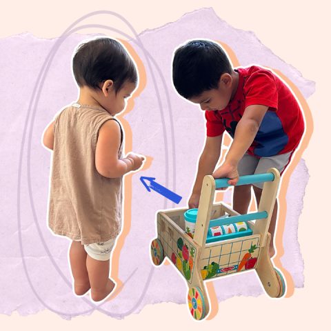 two kids sharing a toy