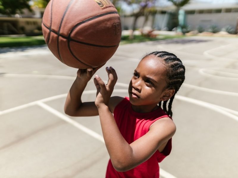 child playing basketball for fun