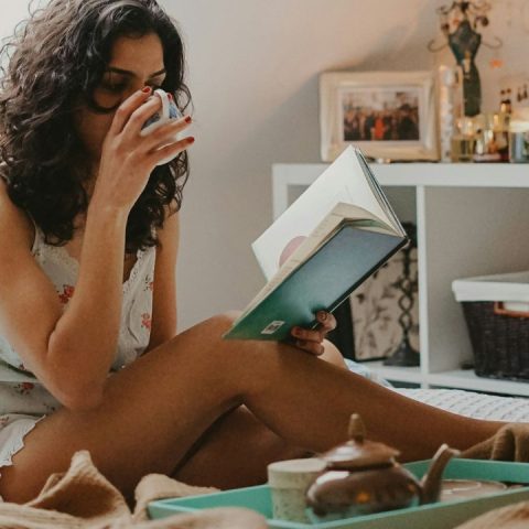 woman reading with cup of tea