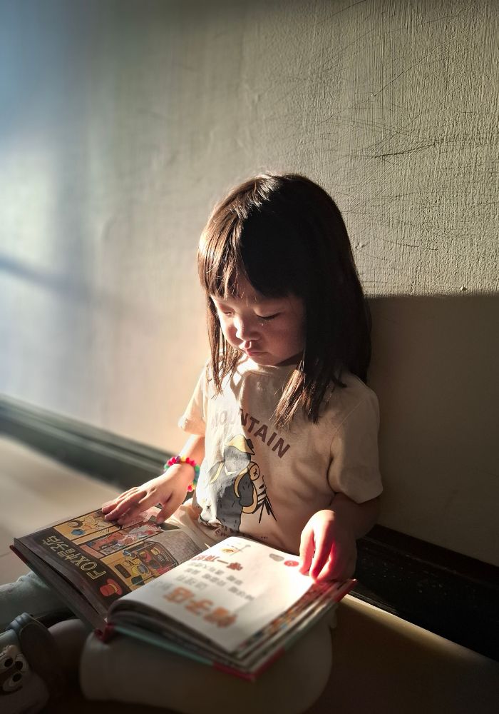 little girl reading quiet time