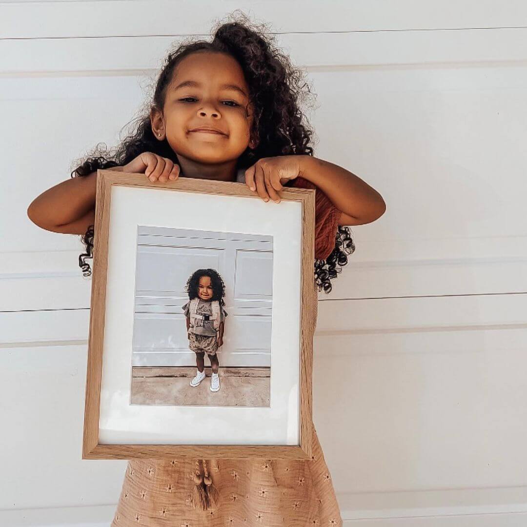 first day of school photo ideas little girl holding last year's first day photo