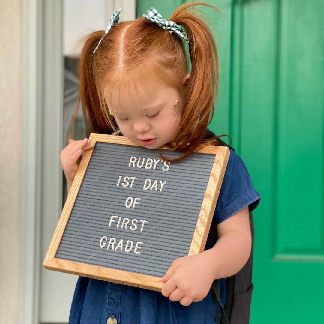 first day of school picture little girl with letterboard