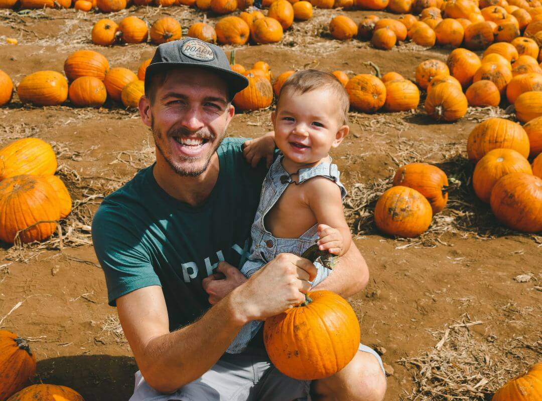 baby and dad at pumpkin patch fall bucket list family activities