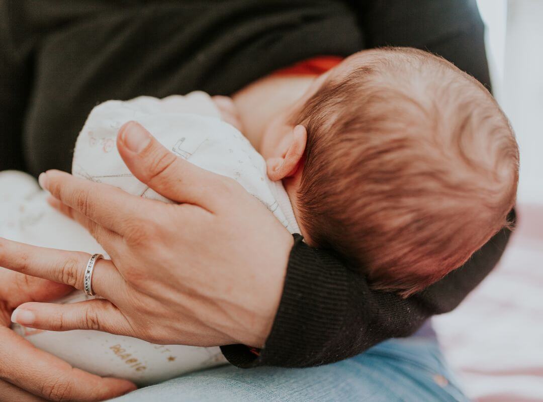 mom breastfeeding with slacker boob