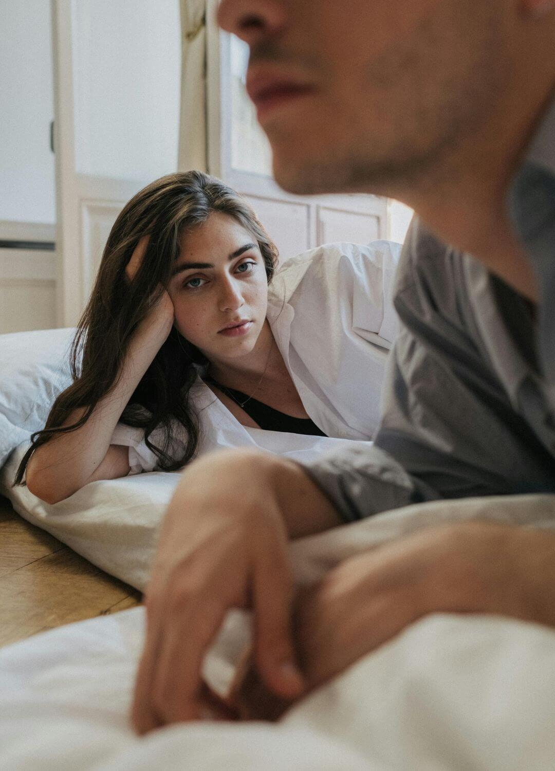 distant couple on bed