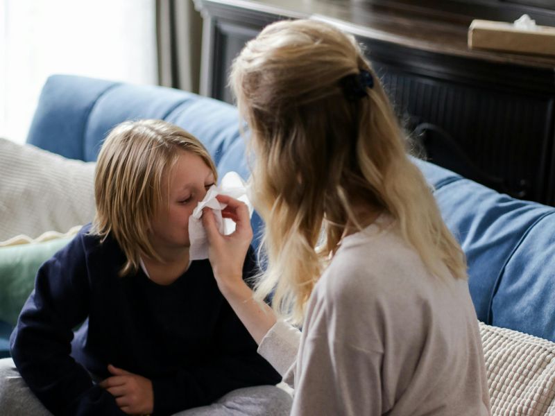 mother taking care of sick child with cold