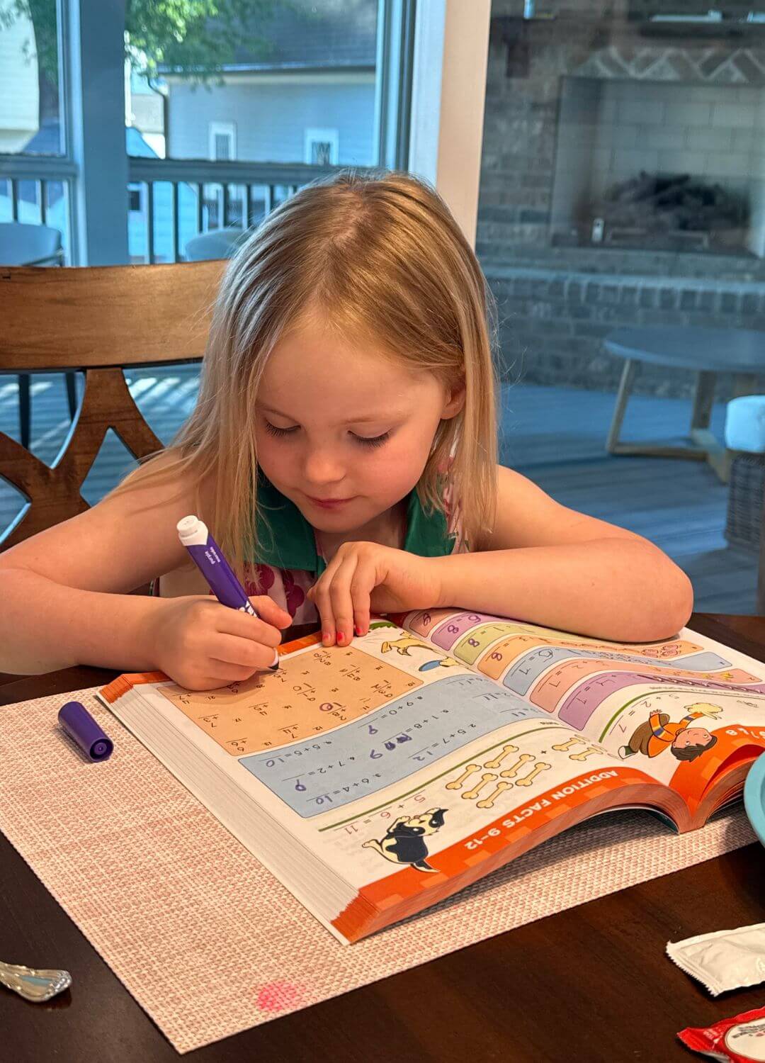 daughter doing kindergarten workbook