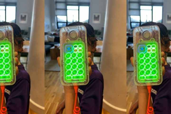 tin can phone review 2026, Child holding the new clear Tin Can phone