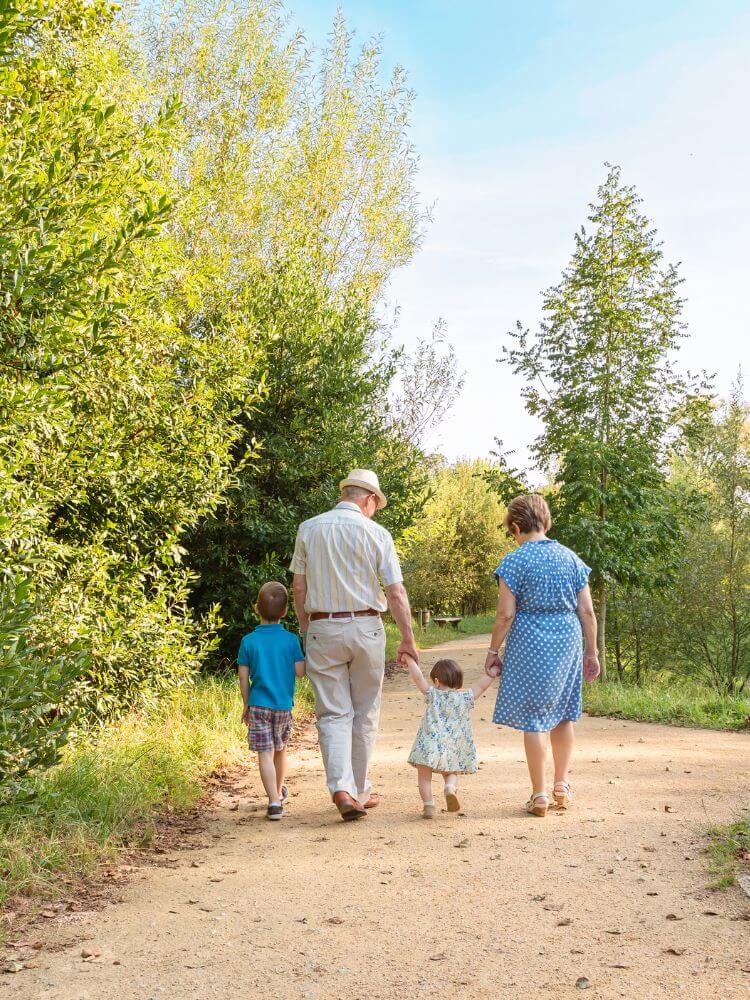 grandparents walking with their grandchildren
