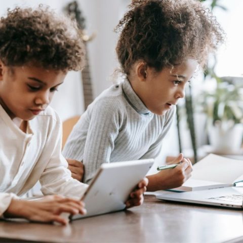 kids having screen time on tablet and laptop